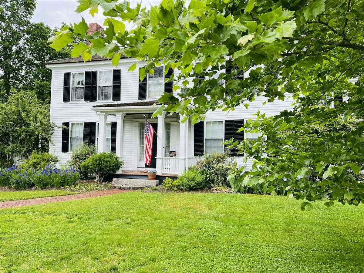 White colonial house with a green lawn in Lexington, Massachusetts